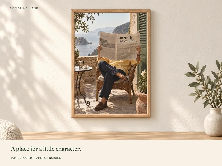 Currently Unavailable print in a wooden frame on a wall; frame not included